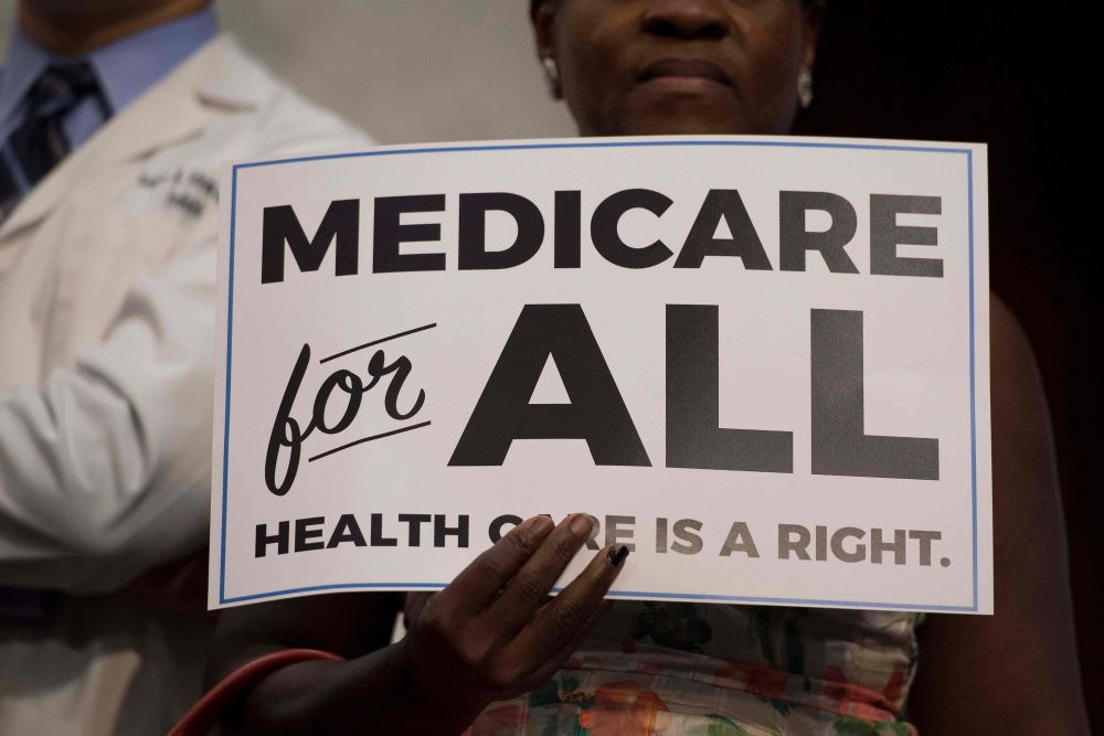 In this photo taken September 13, 2017 a member of the audience holds up a placard as US Senator Bernie Sanders discusses Medicare for All legislation on Capitol Hill in Washington, DC. u00e2u20acu201d AFP file pic