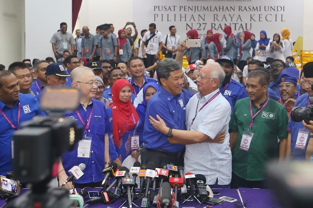 Rantau assemblyman Datuk Seri Mohamad Hasan gets a hug from Datuk Seri Najib Razak after his win, at SJK(C) Bandar Sri Sendayan, April 13,2019. u00e2u20acu201d Picture by Ahmad Zamzahuri