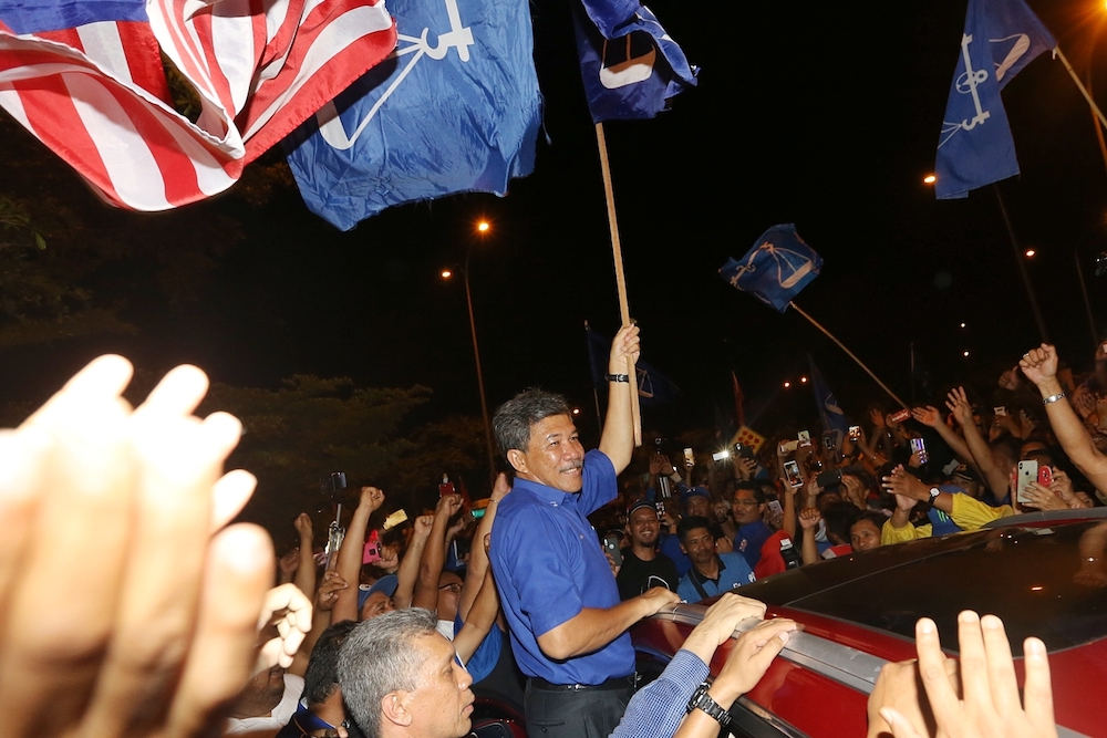 Rantau assemblyman Datuk Seri Mohamad Hasan celebrates his win with Barisan Nasional supporters outside SJK(C) Bandar Sri Sendayan, April 13,2019. u00e2u20acu201d Picture by Ahmad Zamzahuri