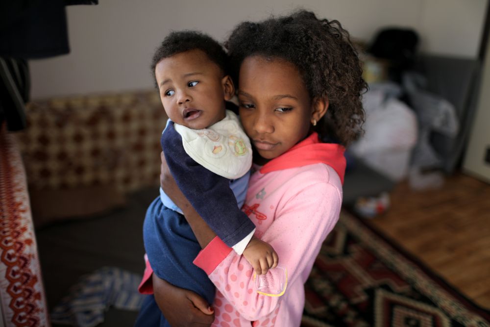 A displaced Libyan girl carries her son at the industrial complex, which is used as a shelter, in Tripoli, Libya April 16, 2019. u00e2u20acu201d Reuters pic