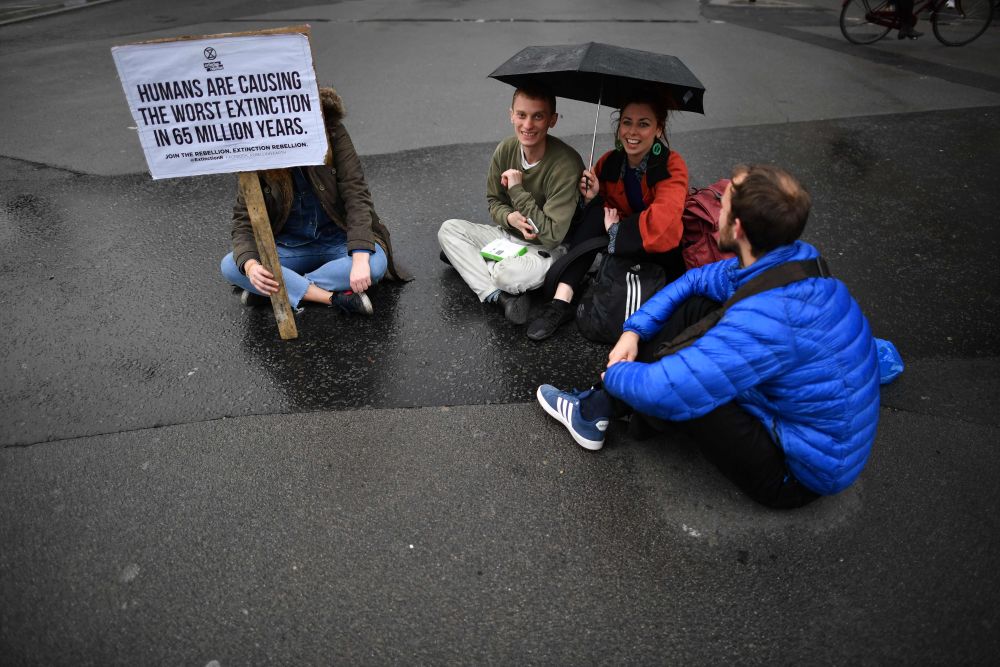Protesters sit in a road near Parliament Square in central London on the second day of an environmental protest by the Extinction Rebellion group, April 16, 2019. u00e2u20acu201d AFP pic