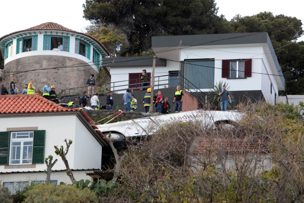 Rescue workers stand next to the wreckage of a bus after an accident in Canico, in the Portuguese Island of Madeira, April 17, 2019. u00e2u20acu201d Reuters pic