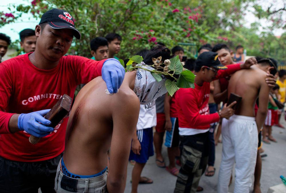 A flagellant has his back wounded to bleed as part of their penitence during the re-enactment of the crucifixion of Jesus Christ for Good Friday in San Juan, Pampanga, north of Manila April 19, 2019. u00e2u20acu201d AFP pic