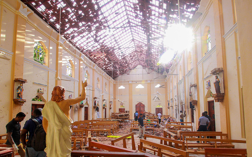 A blood-spattered statue of Jesus Christ is pictured while crime scene officials inspect the site of a bomb blast, as the sun shines through the blown-out roof, inside St Sebastianu00e2u20acu2122s Church in Negombo, Sri Lanka April 21, 2019. u00e2u20acu201d Reuters pic