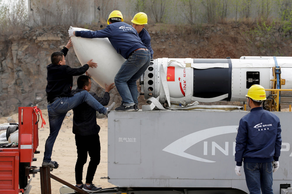 Engineers install the payload fairing before a test launch of LinkSpace’s reusable rocket RLV-T5, also known as NewLine Baby, in Longkou, Shandong province, April 18, 2019. — Reuters pic