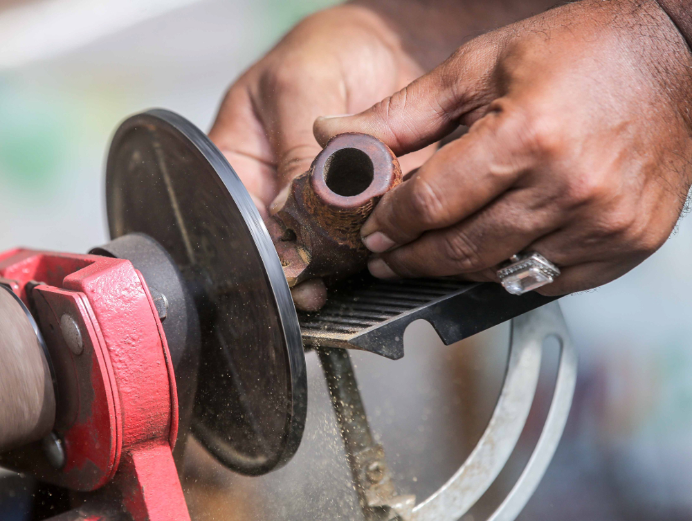 Zulkarnain Saidin shapes a pipe using a machine at his home in Chemor, Perak April 1, 2019.