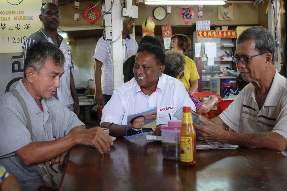 Pakatan Harapan's Dr S. Streram (centre) chats with some Rantau residence during a walkabout in Kuala Sawah April 1, 2019. u00e2u20acu201d Picture by Yusof Mat Isa