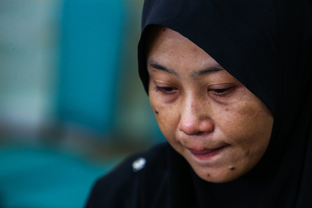 Norhayati Mohd Arifin cries during the announcement of Suhakamu00e2u20acu2122s public inquiry findings into the disappearances of pastor Raymond Koh and Amri Che Mat in Kuala Lumpur April 3, 2019. u00e2u20acu201d Picture by Hari Anggara