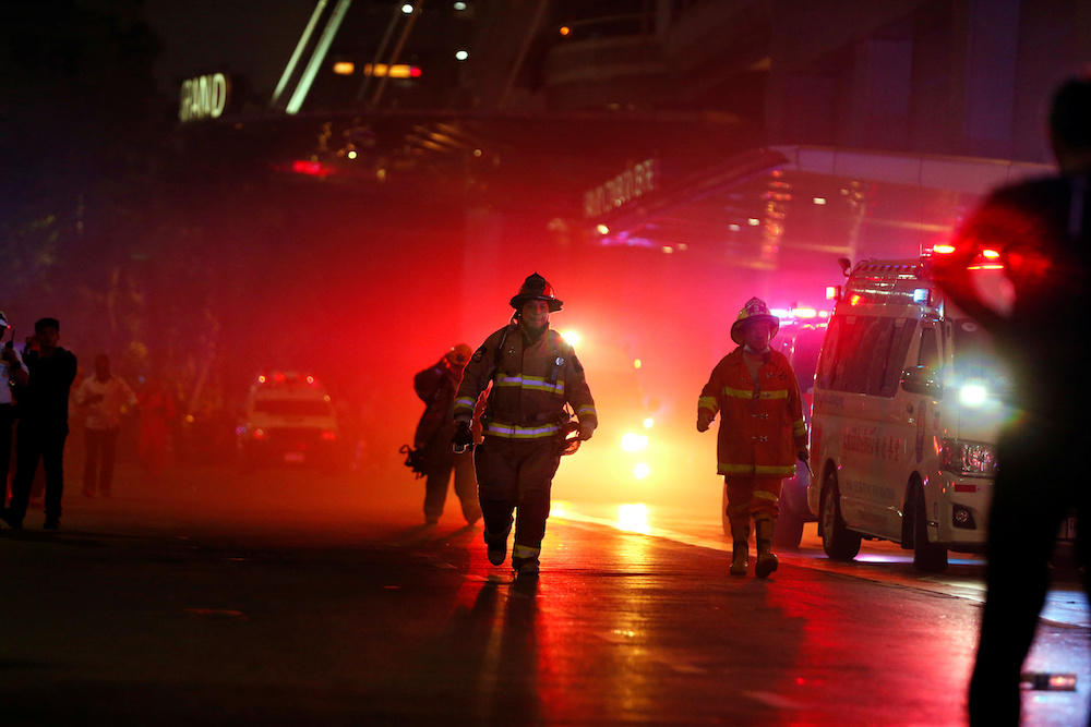 Rescue workers work after the Central World Complex was evacuated due to a fire, in Bangkok April 10, 2019. — Reuters pic