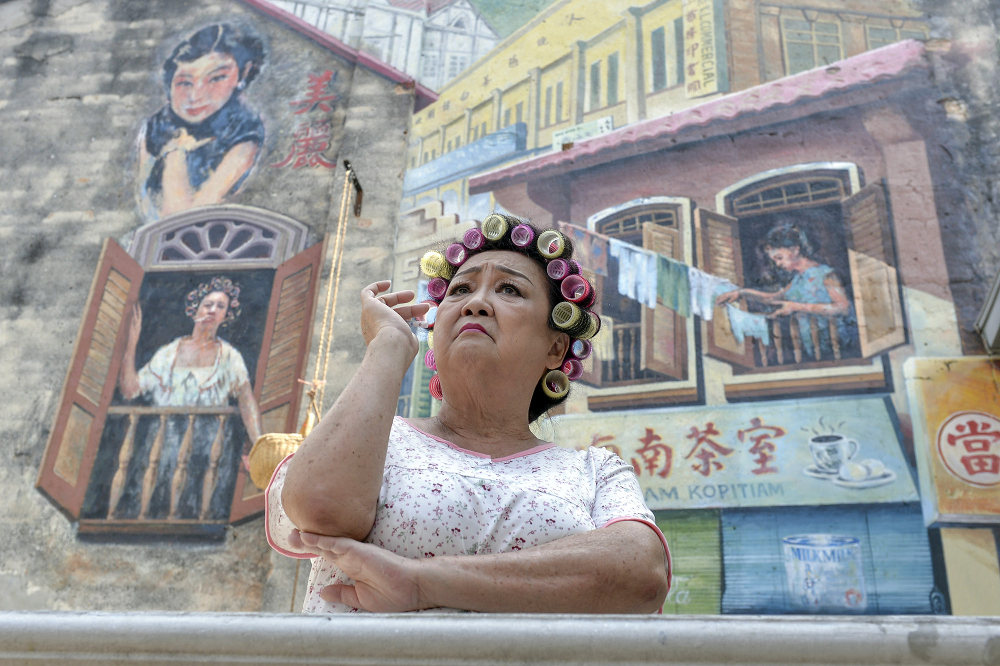 An actress is seen here evoking the character of a landlady in Kwai Chai Hong, where you can come to be transported back in time. u00e2u20acu201d Picture by Mukhriz Hazim