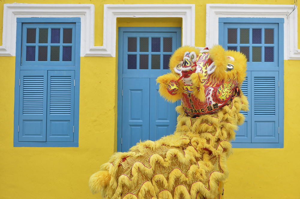 A lion dance along Lorong Panggung outside a restored shophouse painted in yellow and blue, which Chong Keat Aun had criticised on Facebook. 