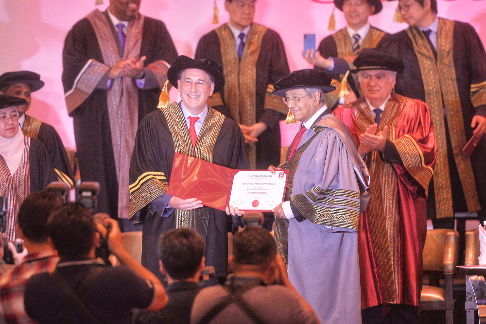 Tun Dr Mahathir Mohamad receive a Bachelor of Business Management from Asia School of Business dean and president Prof Charles Fine at the Asia School of Business graduation ceremony April 14, 2019. u00e2u20acu201d Picture by Shafwan Zaidon 