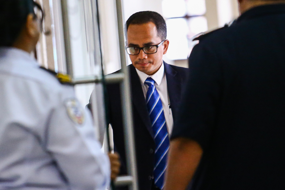 Bank Negara Malaysia manager Azizul Adzani Abdul Ghafar arrives at the Kuala Lumpur Court Complex April 16, 2019. u00e2u20acu201d Picture by Hari Anggara