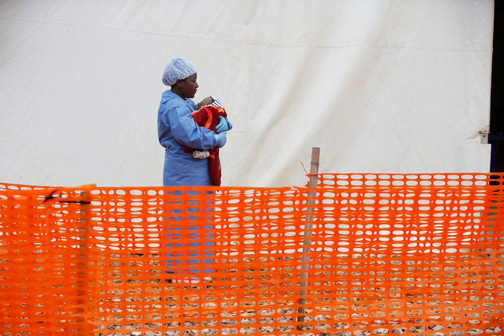 Rachel Kahindo, Ebola survivor working as a caregiver to babies who are confirmed Ebola cases, holds an infant outside the red zone at the Ebola treatment centre in Butembo March 25, 2019. u00e2u20acu201d Reuters pic