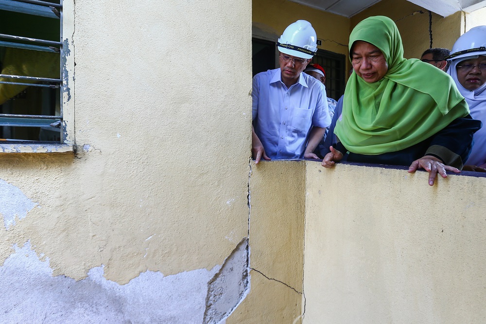 Minister of Economic Affairs Datuk Seri Mohamed Azmin Ali (left) and Housing and Local Government Minister Zuraidah Kamaruddin (right) during a visit to Taman Keramat Permai Flat in Kuala Lumpur April 29, 2019. 