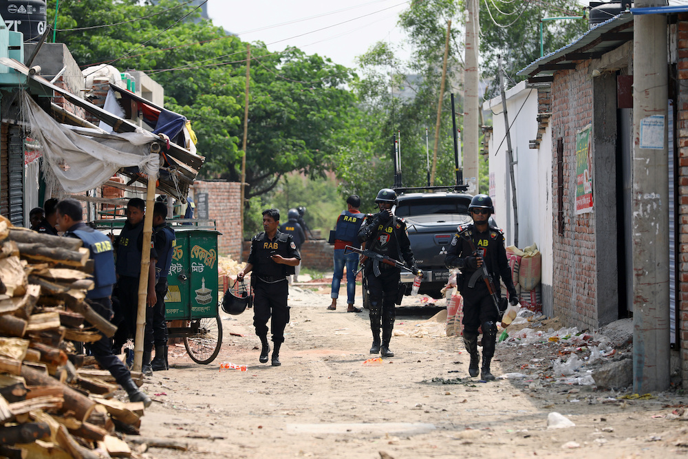 Security personnel walk near a militant den in the Bosila area where militants were killed in a blast in Dhaka April 29, 2019. u00e2u20acu201d Reuters picnn