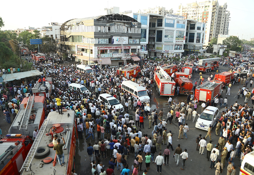 Fire trucks and ambulances are seen after a fire broke out in a four-story commercial building in Surat, in the western state of Gujarat May 23, 2019. u00e2u20acu201d Reuters picnn
