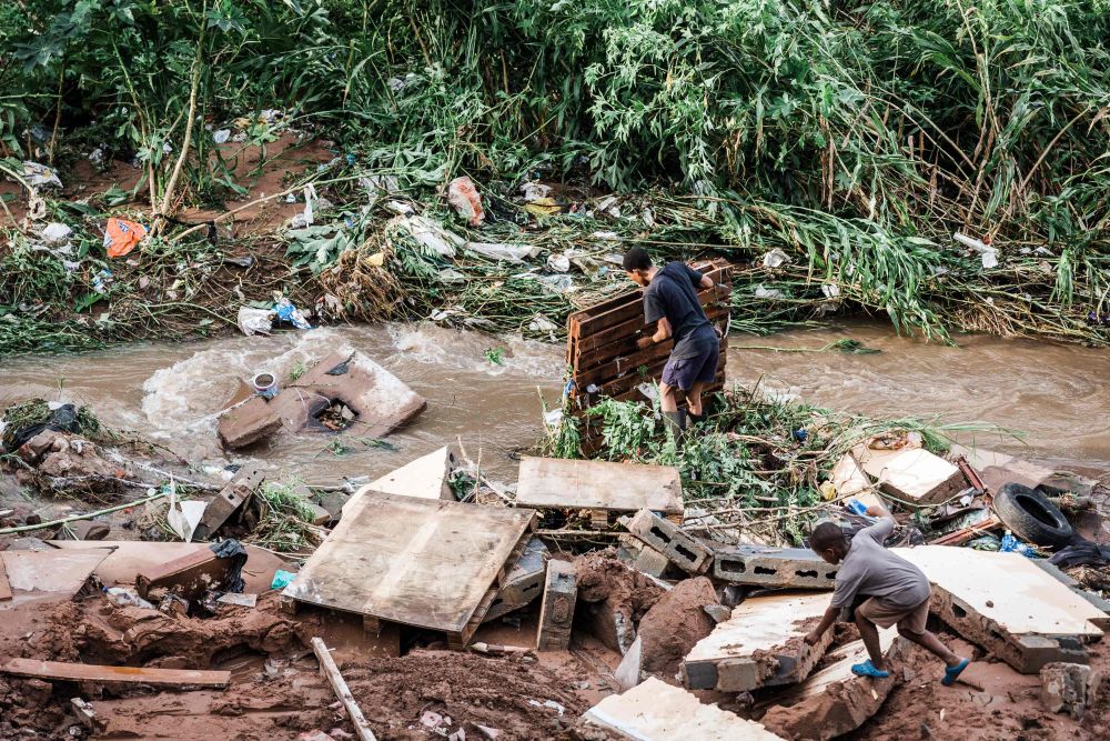 A man tries to salvage some of his furniture at an informal settlement of BottleBrush, south of Durban, after torrential rains and flash floods destroyed his home, April 23, 2019. u00e2u20acu201d AFP pic
