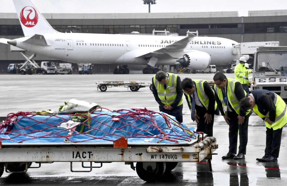 A coffin containing the body of Kaori Takahashi, a Japanese woman killed in the terrorist bombings in Sri Lanka, arrives as airport officials bow at Narita international airport in Narita, Japan April 25, 2019. u00e2u20acu201d Kyodo pic via Reuters