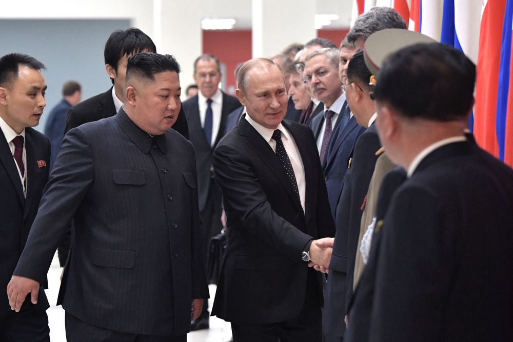 Russian President Vladimir Putin and North Korean leader Kim Jong-un greet members of the delegations prior to their talks in the far-eastern Russian port of Vladivostok April 25, 2019. u00e2u20acu201d Alexey Nikolsky/Sputnik pic via AFP