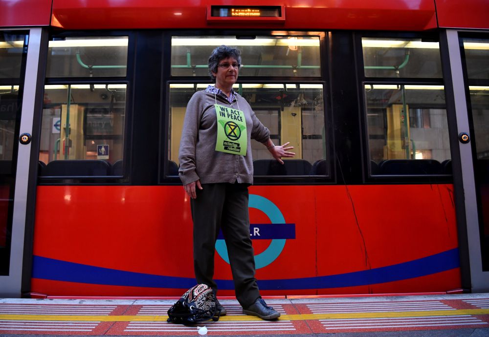 Protester Diana Warner glues her hand to a train during the Extinction Rebellion protest in London, Britain April 25, 2019. u00e2u20acu201d Reuters pic