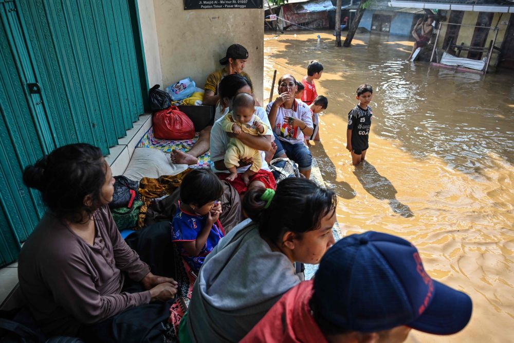 Residents take shelter on higher ground from floodwaters in Jakarta April 26, 2019, after several areas were affected by heavy rainfall. u00e2u20acu201d AFP pic