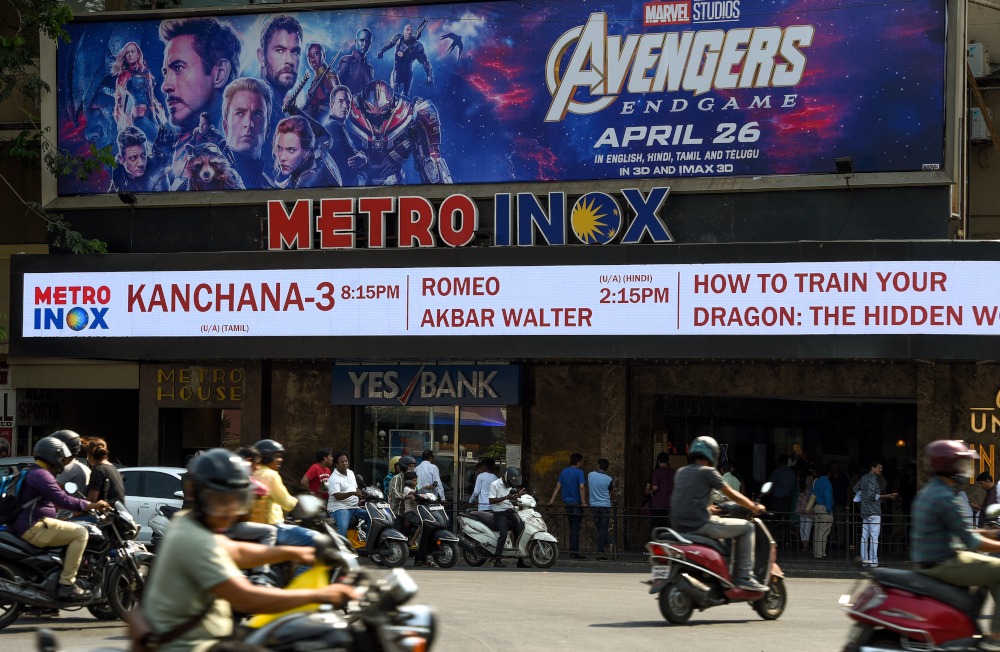 Indian vehicles go past a movie theatre displaying a poster of the latest u00e2u20acu02dcAvengersu00e2u20acu2122 movie, in Mumbai April 25, 2019. u00e2u20acu201d AFP pic 
