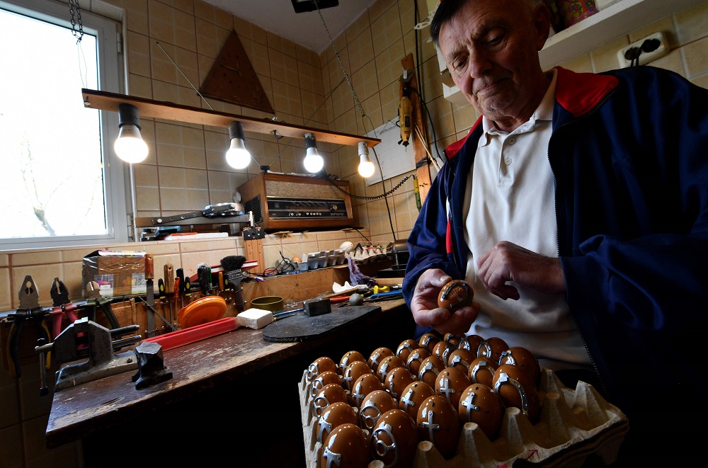 Stjepan Biletic, 71, from the Central-Bosnian town of Kresevo, shows a full stack of miniature horseshoe nailed eggs in his workshop April 17, 2019. — AFP pic