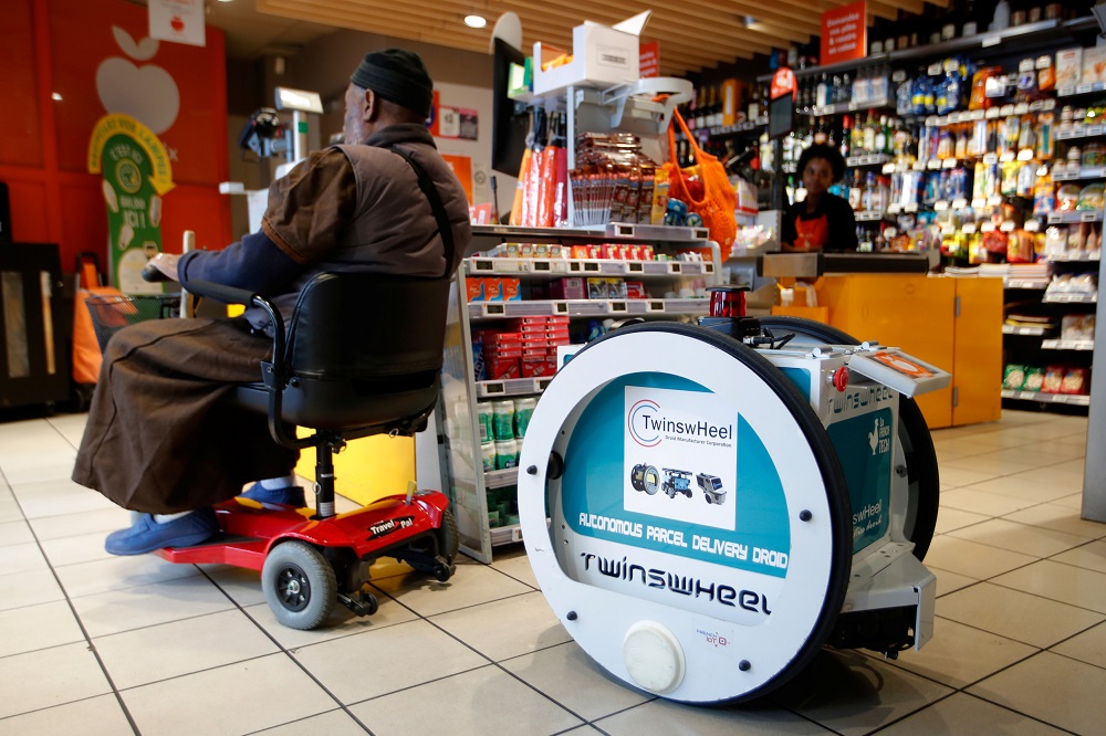 A man does his shopping at a store using an autonomous robot, shaped and inspired by Star Wars R2D2, in a test for the delivery of groceries by Franprix supermarket chain in the 13th district of Paris, France, April 17, 2019. u00e2u20acu201d AFP pic