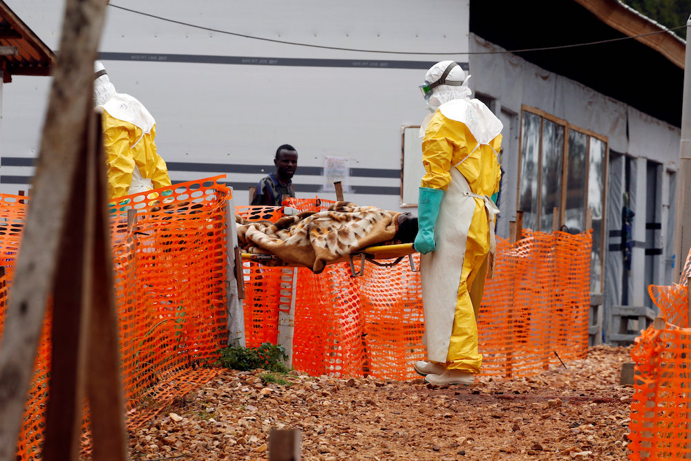 Health workers carry a newly admitted confirmed Ebola patient into a treatment centre in Butembo in the eastern Democratic Republic of Congo, March 28, 2019