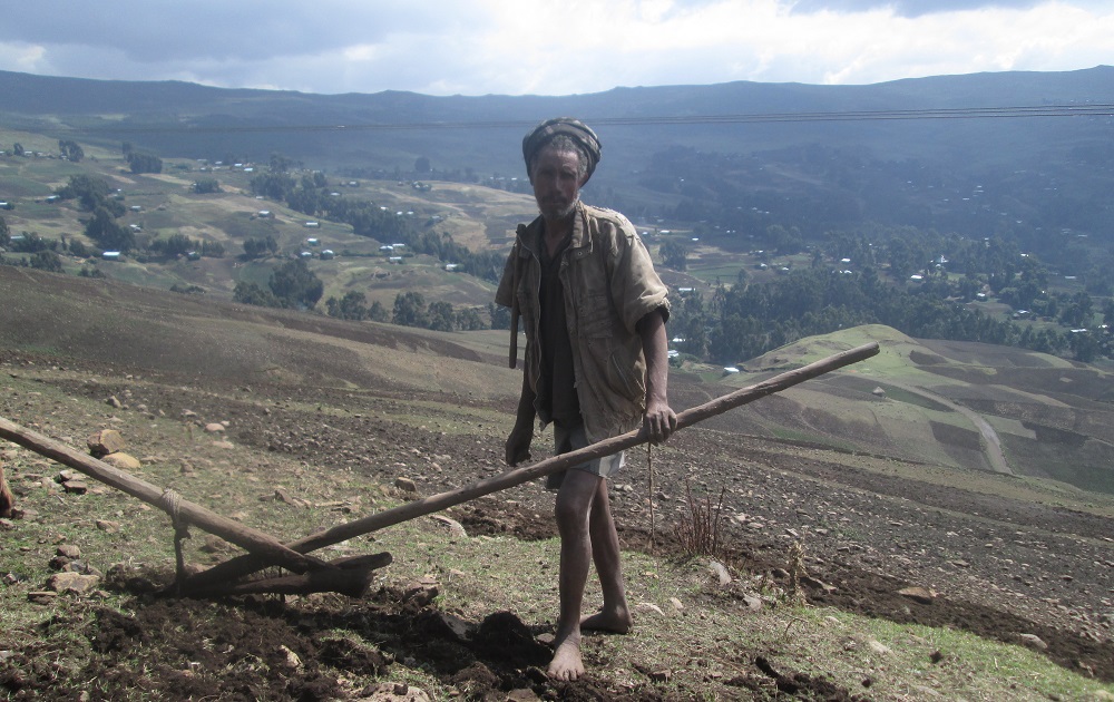 Farmer Babel Tena works in a field cultivating barley, beans and potatoes, on the side of the Choke Mountain, in Ethiopia March 13, 2019. u00e2u20acu201d Thomson Reuters Foundation pic