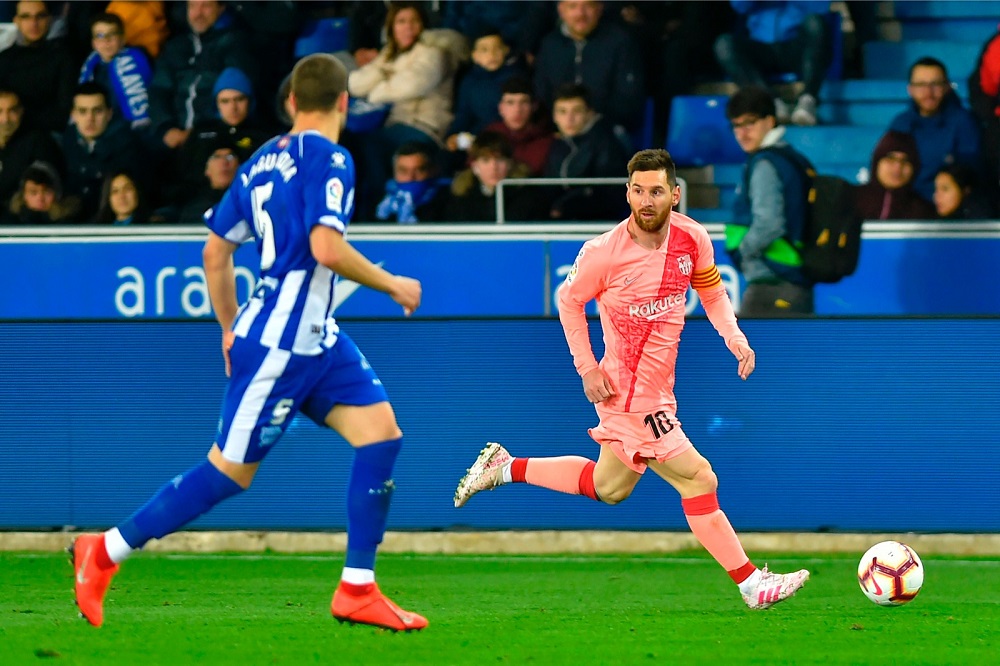 Barcelonau00e2u20acu2122s Argentinian forward Lionel Messi (right) runs with the ball during the Spanish league football match between Deportivo Alaves and FC Barcelona at the Mendizorroza stadium in Vitoria April 23, 2019. u00e2u20acu201d AFP pic