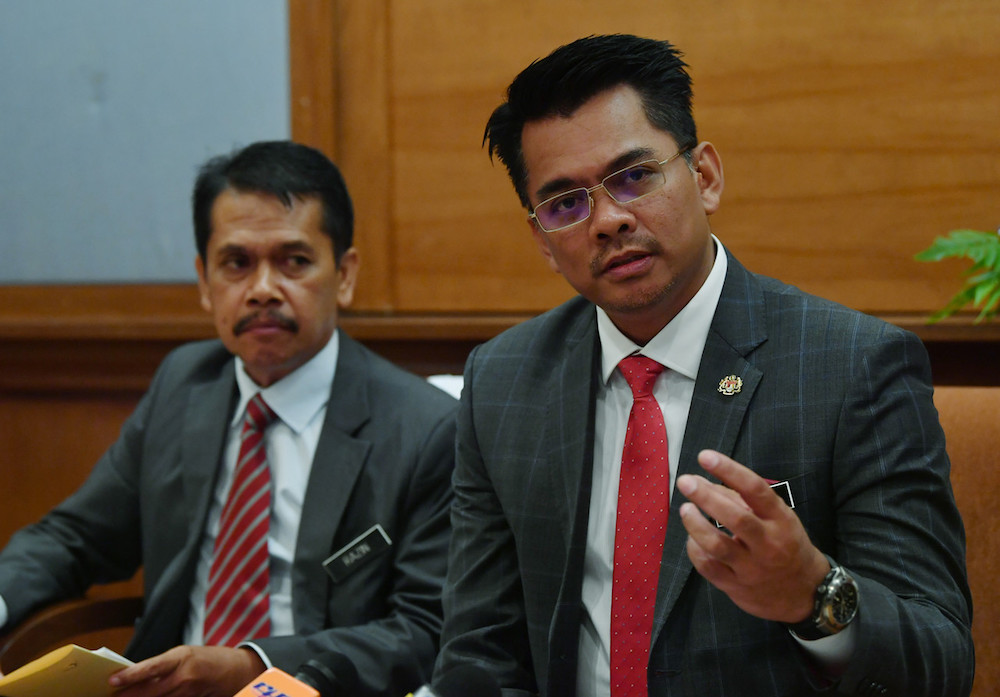 Deputy Home Minister Datuk Mohd Azis Jamman (right) speaks to reporters in Putrajaya March 22, 2019. u00e2u20acu201d Bernama pic