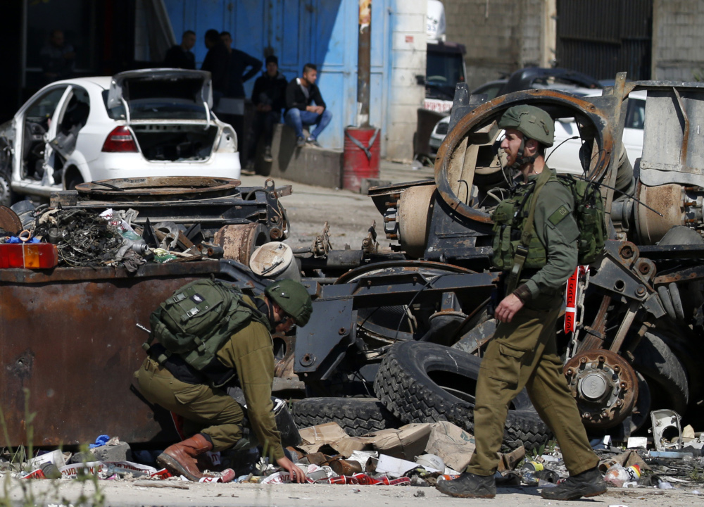 Israeli soldiers inspect the site where a Palestinian man was killed after he reportedly tried to stab an Israeli driver at a junction south of Nablus in the occupied West Bank April 3, 2019. u00e2u20acu201d AFP pic  