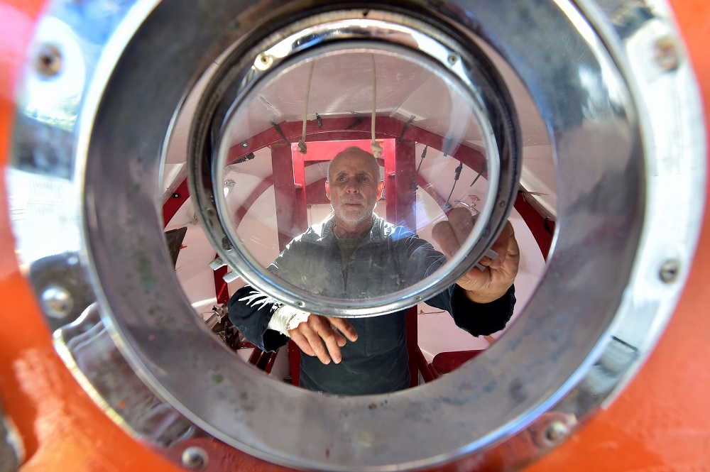 Jean-Jacques Savin, a former paratrooper, 71, working on the construction of a ship made from a barrel. u00e2u20acu201d AFP pic