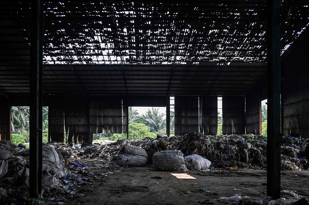 This picture taken on March 8, 2019 shows plastic waste at an abandoned factory in Jenjarom, a district of Kuala Langat, outside Kuala Lumpur. u00e2u20acu201d AFP pic