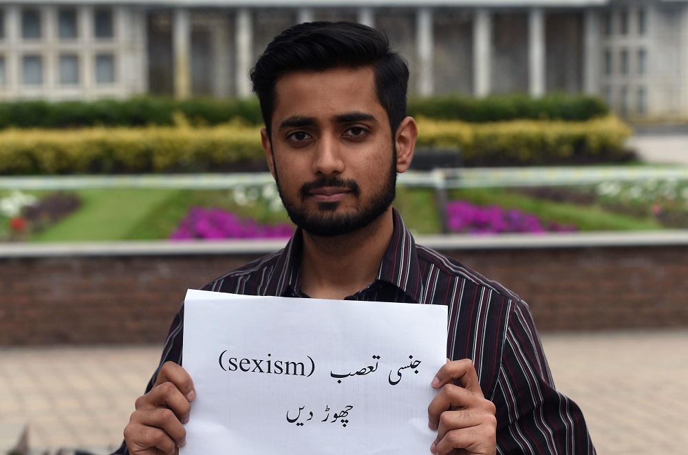 In this picture taken on March 18, 2019, Pakistani activist Abdullah Mahsood holds a placard that reads u00e2u20acu02dcstop sexual harassmentu00e2u20acu2122 as he gives an interview to AFP in Lahore. u00e2u20acu201d AFP pic 