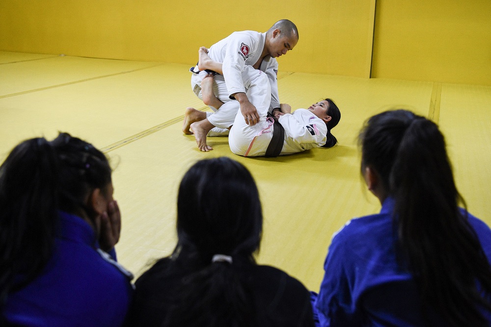 This photo taken on February 5, 2019 shows jiu-jitsu world champion Meggie Ochoa (top right) demonstrating a technique during a session at a gym in Manila. u00e2u20acu201d AFP pic      
