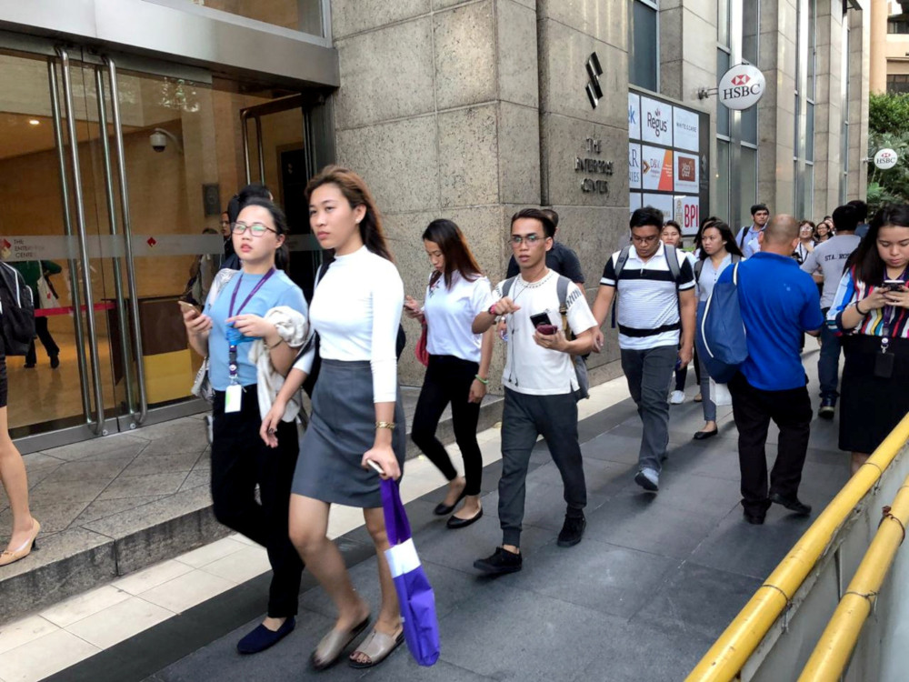 Employees walk outside after being evacuated from the office building after an earthquake in Makati City, Philippines, April 22, 2019. u00e2u20acu201d Reuters pic 
