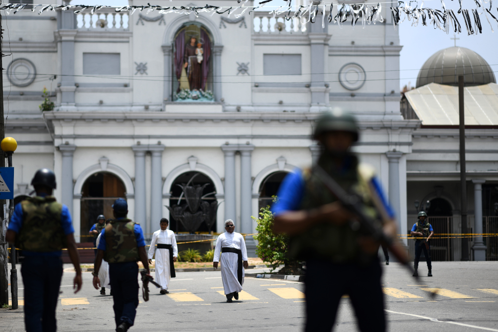 Priests walk on a blocked street as soldiers stand guard outside St Anthonyu00e2u20acu2122s Shrine in Colombo April 25, 2019, following a series of bomb blasts targeting churches and luxury hotels on the Easter Sunday in Sri Lanka. u00e2u20acu201d AFP pic 