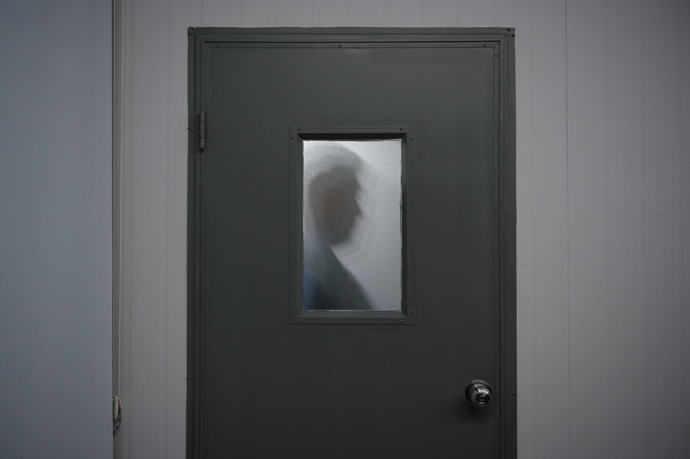In a photo taken on March 19, 2019, a 27-year-old former South Korean army conscript, who asked for anonymity to be able to tell his story without fear of exposure, poses for a photo behind a door, at an office in Seoul. u00e2u20acu201d AFP pic        