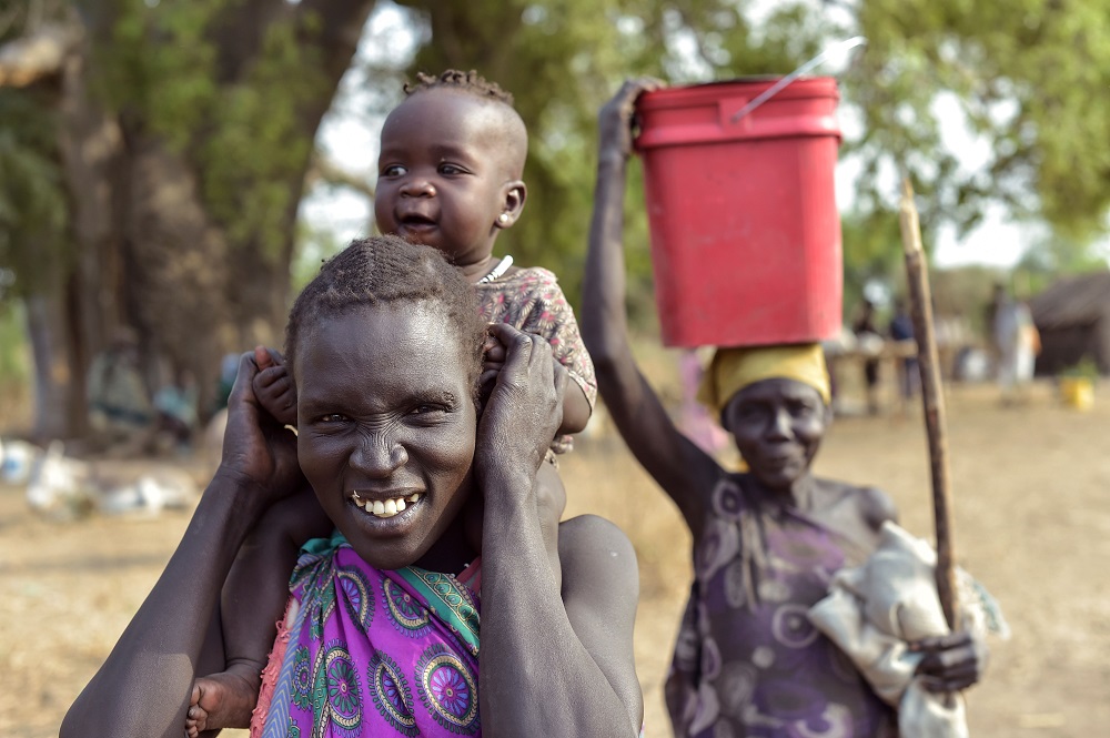 A woman carries her child at a market in Udier town, South Sudan March 7, 2019. u00e2u20acu201d AFP pic 