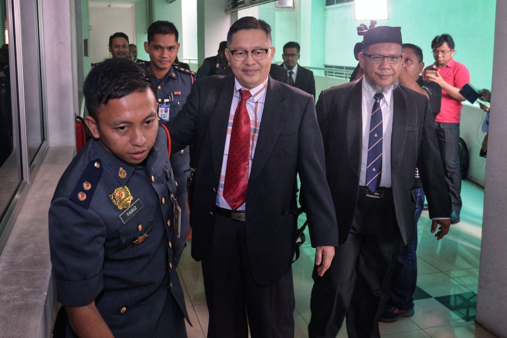 Prof Dr Shahrom Abd Wahid (centre) leaves after attending the inquest into fireman Muhammad Adib Mohd Kassimu00e2u20acu2122s death at the Shah Alam High Court April 9, 2019. u00e2u20acu201d Picture by Shafwan Zaidon