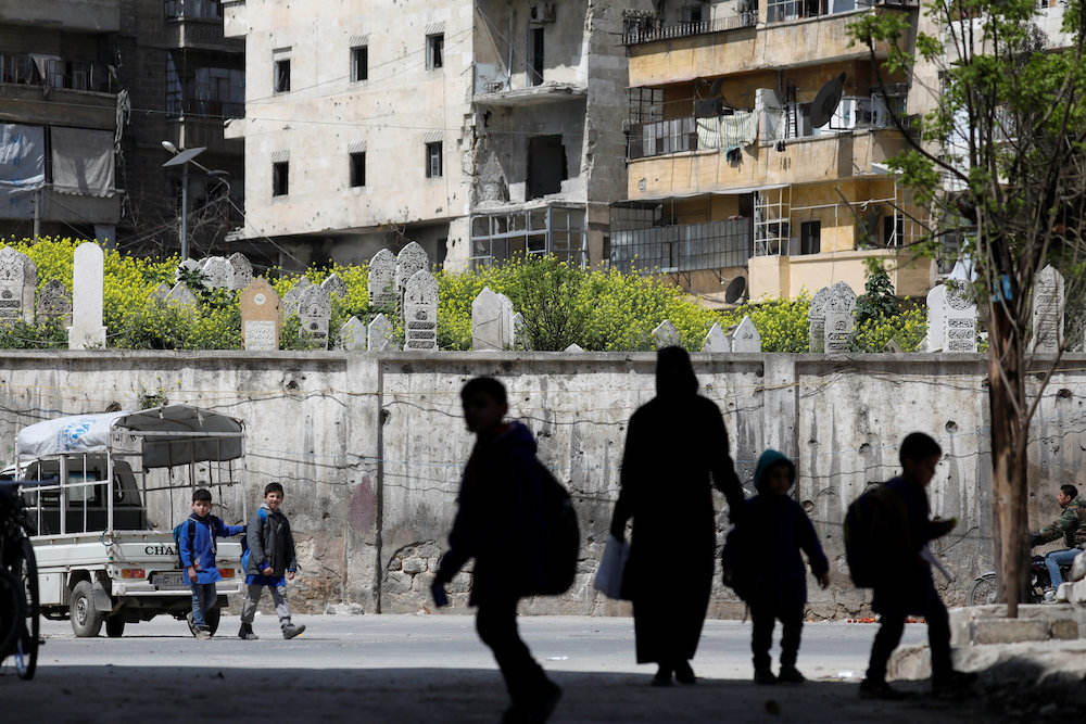Students walk together near a cemetery in Aleppo's Kallaseh neighbourhood, Syria April 10, 2019. u00e2u20acu201d Reuters pic