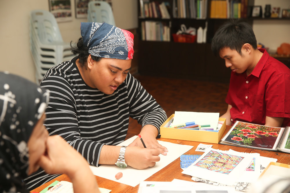 Nurul, who has learning disabilities and emotional difficulties, has gained a lot by learning how to express herself through art. — Picture by Choo Choy May
