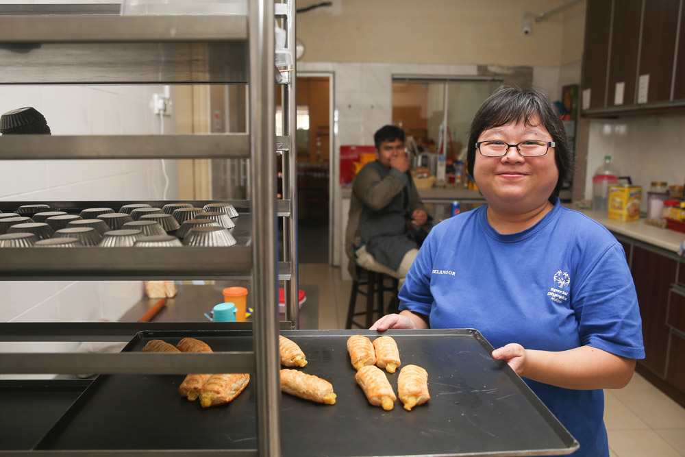 Wendy Yeong poses with some of the baked goods in United Voice’s kitchen. — Picture by Choo Choy May