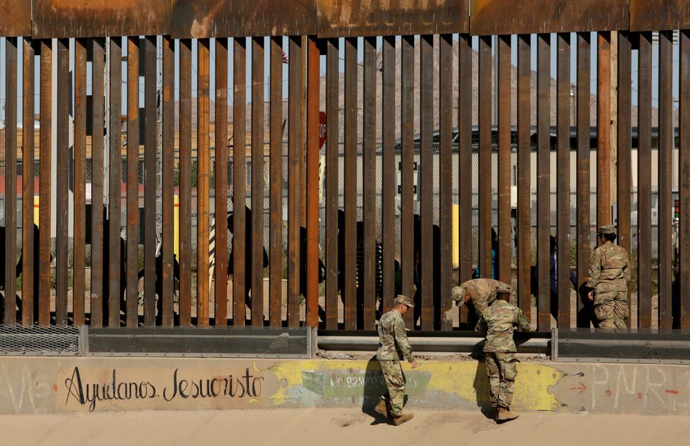 US soldiers walk next to the border fence between Mexico and the United States, as migrants are seen walking behind the fence, after crossing illegally into the US to turn themselves in, in El Paso, Texas, US, April 3, 2019. u00e2u20acu201d Reuters pic