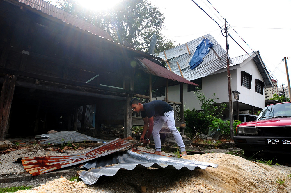 At least 50 houses in Tanjung Tokong here were damaged after they were hit by a water spout and heavy rains in Penang April 1, 2019. u00e2u20acu201d Bernama pic