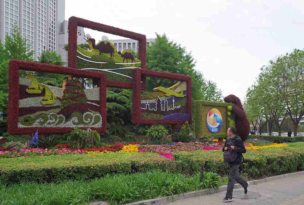A man walks past a flower installation set up for the upcoming Belt and Road Forum in Beijing April 18, 2019. u00e2u20acu201d Jia Tianyong/CNS pic via Reuters