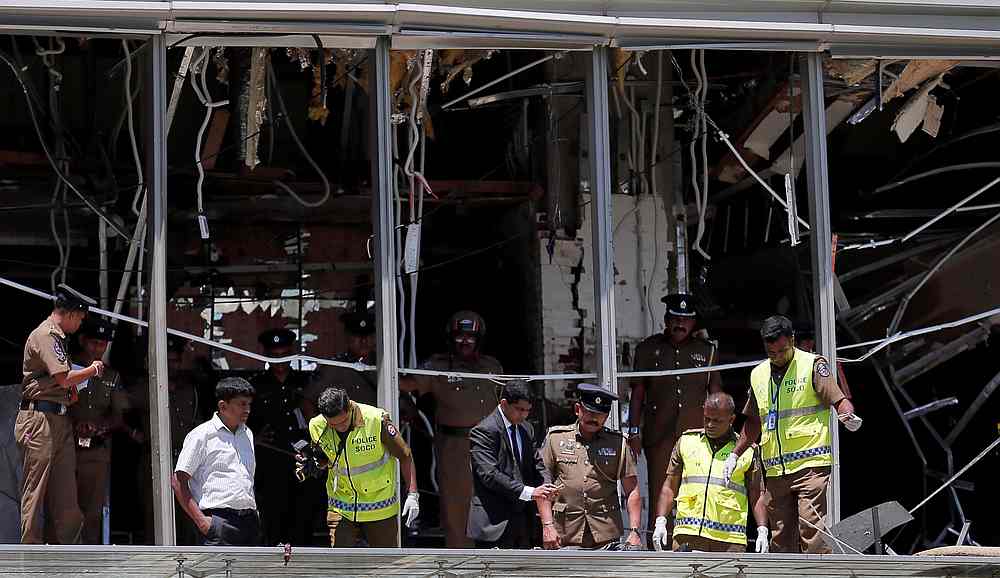 Crime scene officials inspect the explosion area at Shangri-La hotel in Colombo, Sri Lanka April 21, 2019. u00e2u20acu201d Reuters picn